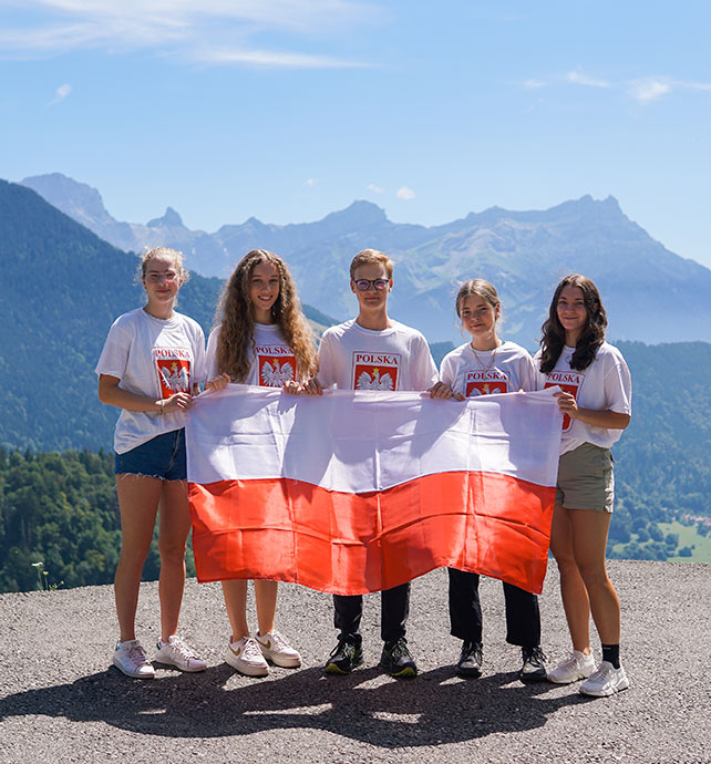 students holding a flag from their country
