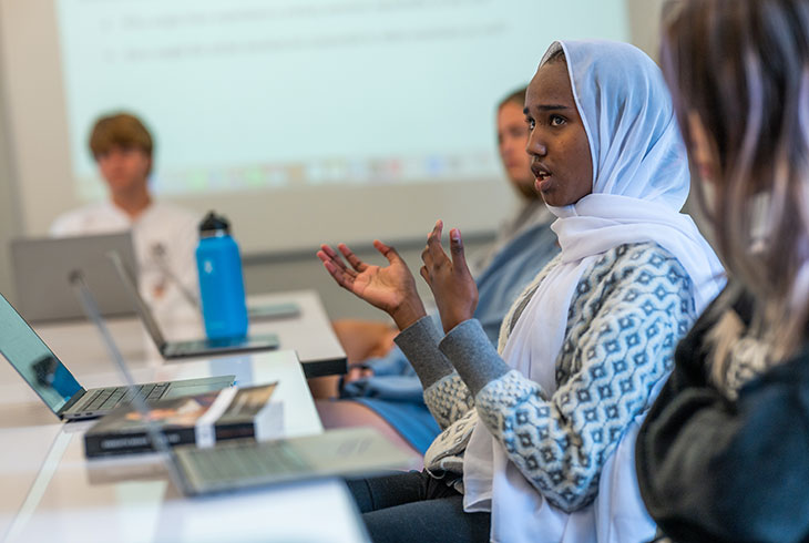 opportunity-becomes-impact A female international student wearing a head scarf in class at a US boarding school