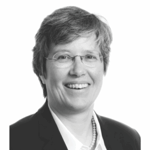 black and white headshot of mid aged white woman, black suit